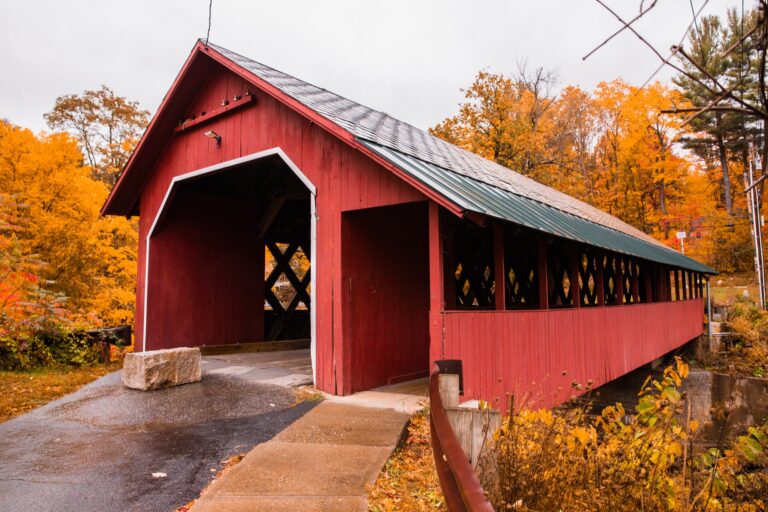 Vermont covered bridge surrounded by fall foliage near the Green Mountains and the Mad River Valley